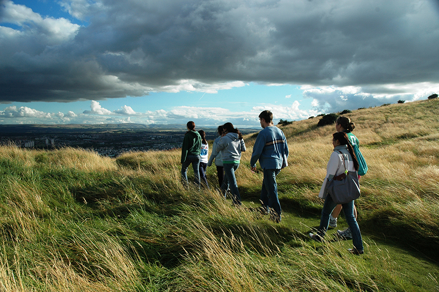 Students walk across a field in Scotland